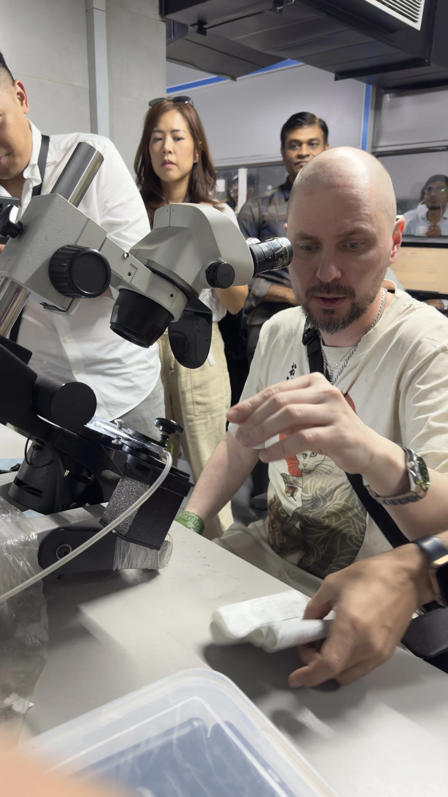 AZENA inspecting stones at the microscope with sourcing partners.